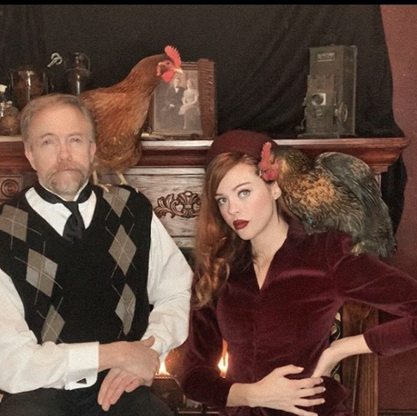 Tewres with her father and two chickens, enjoying happy family life.